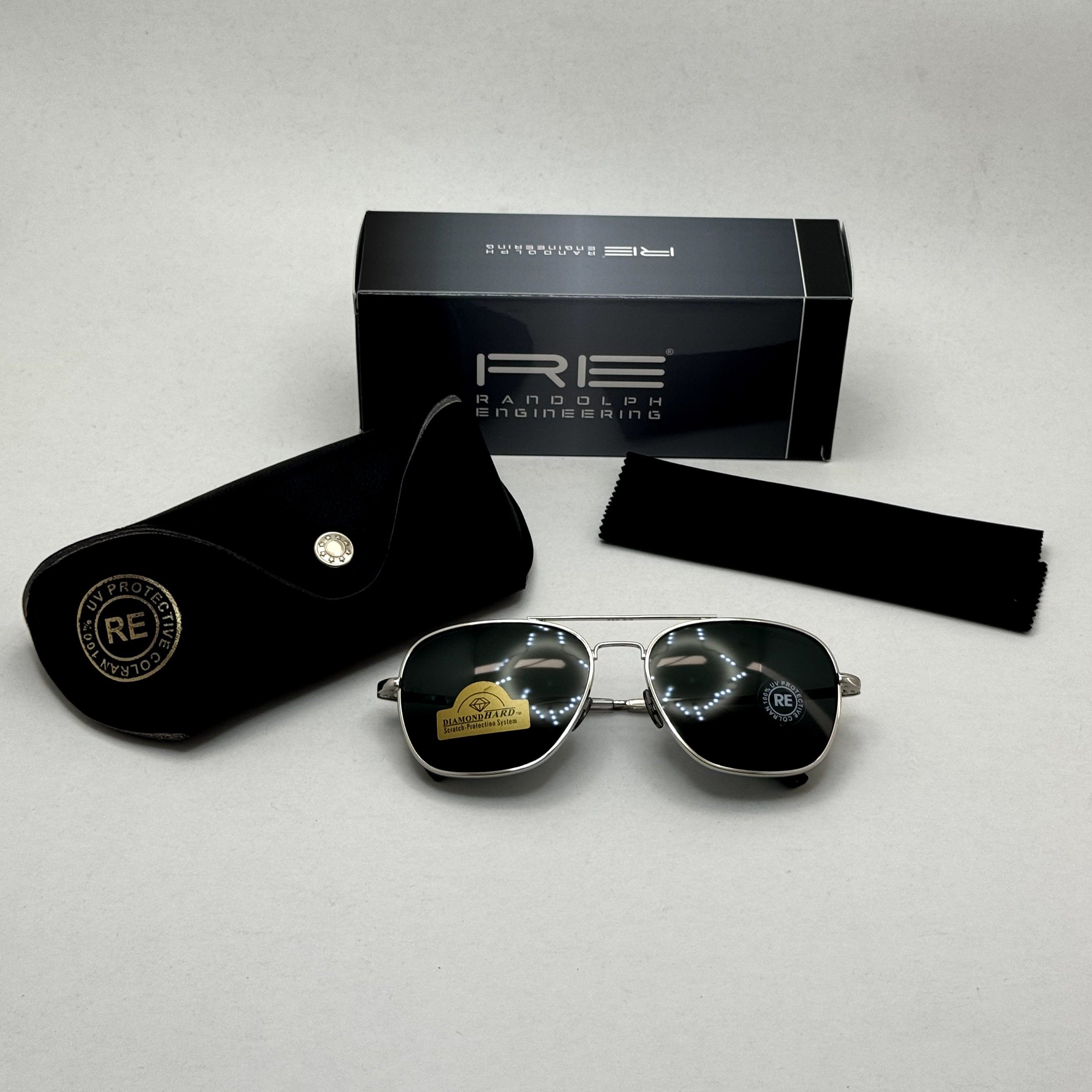 عینک آفتابی خلبانی رندولف شیشه سنگ آنتی رفلکس مشکی فریم نقره ای فول پک RANDOLPH AVIATOR RE 58 WHITE GOLD